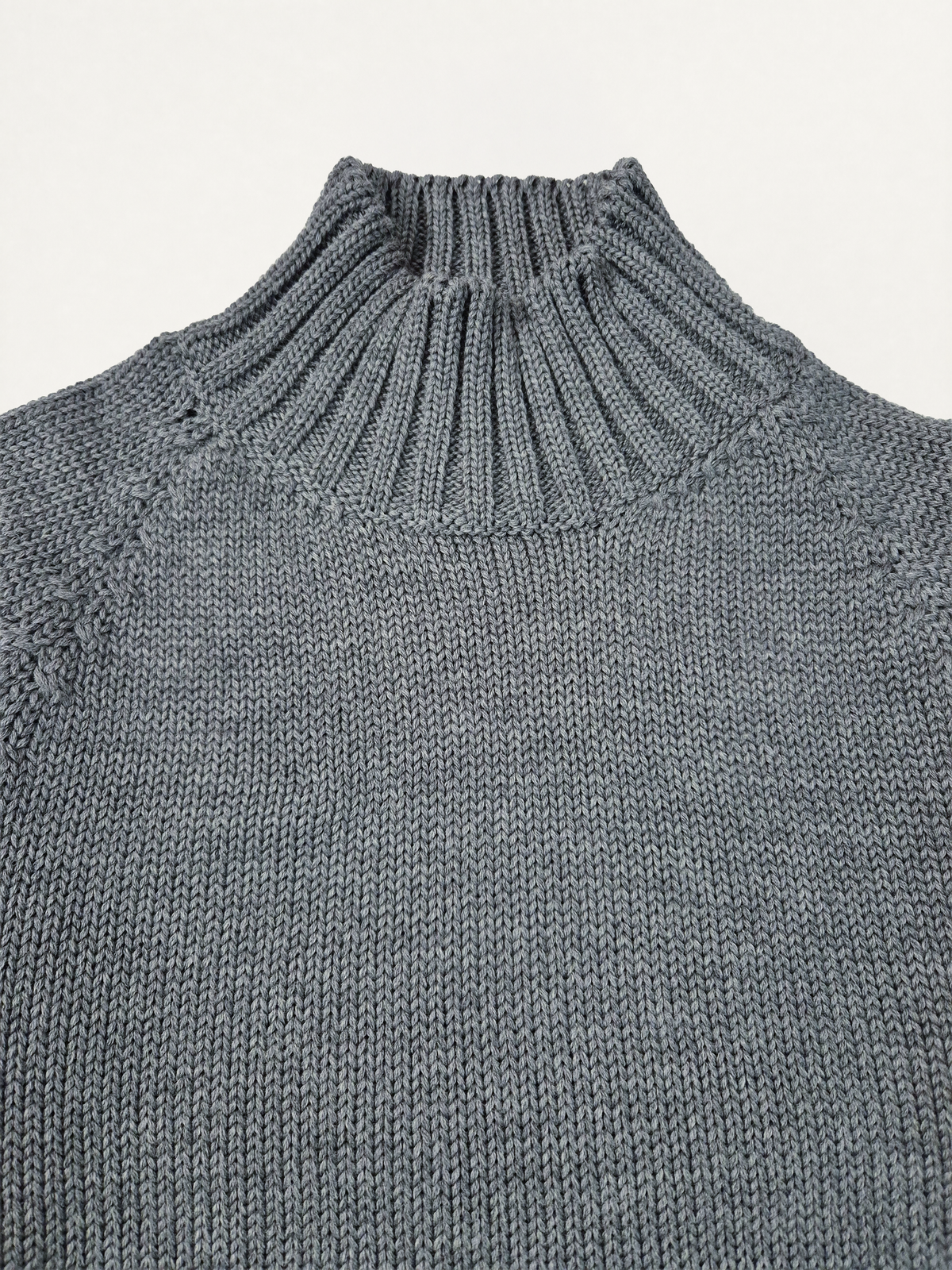 Dettaglio del collo alto del dolcevita donna in lana merino colore grigio melange