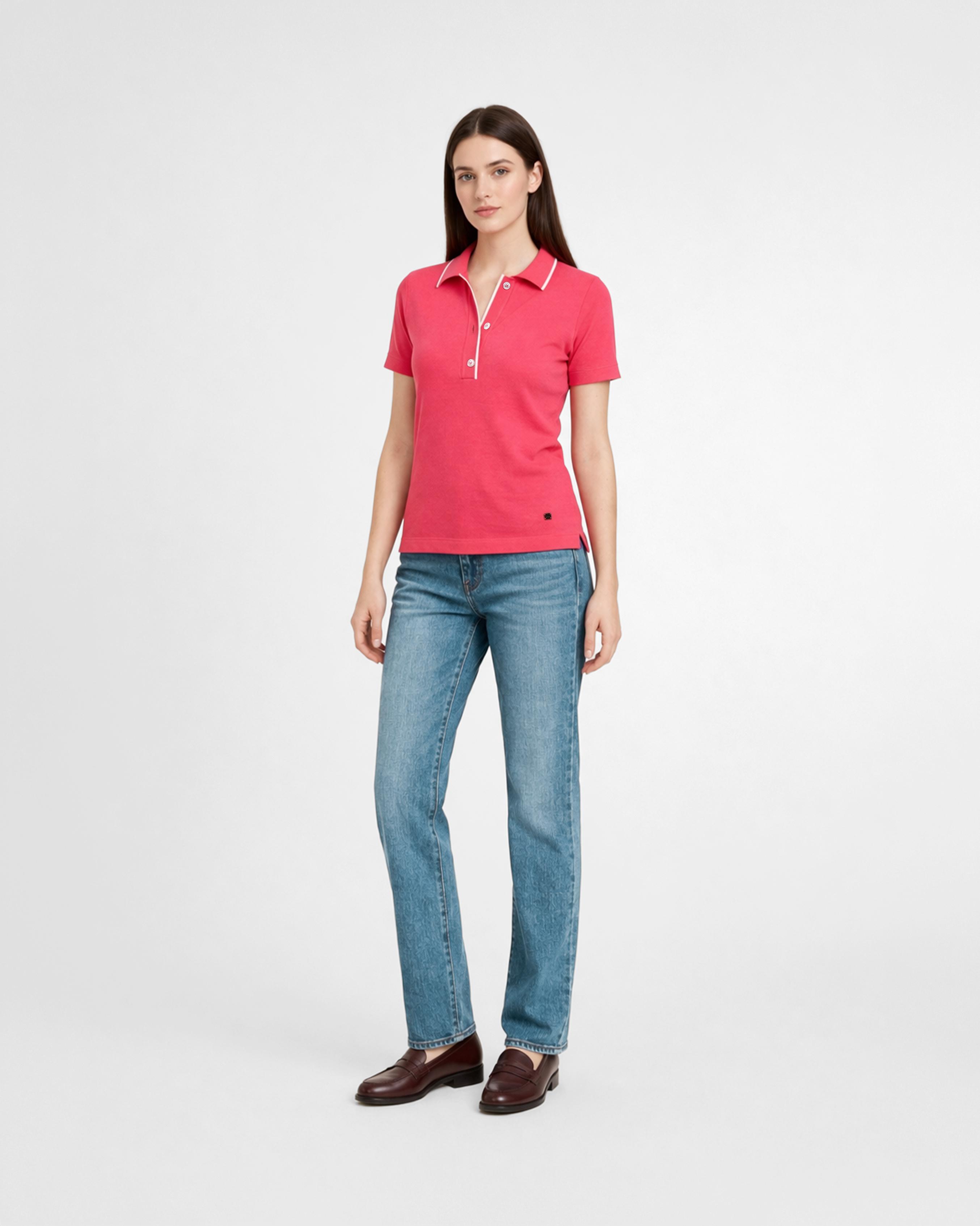 Polo donna in maglia di cotone rosa corallo con colletto e bordi bianchi indossata su sfondo bianco
